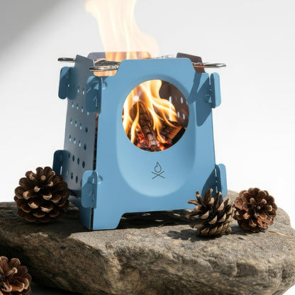 The Stöker Stove by Überleben in blue with fire on rock.
