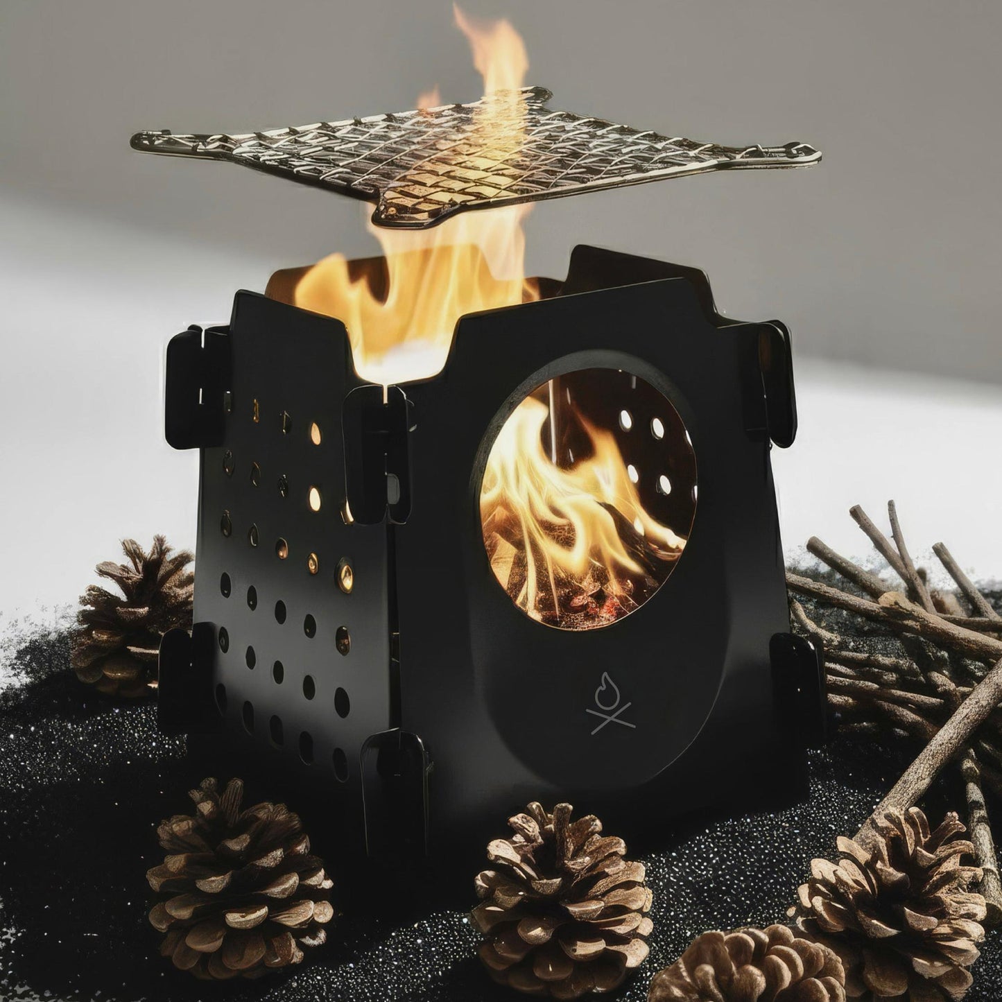 The Stöker Stove by Überleben lit with pine cones and twigs.