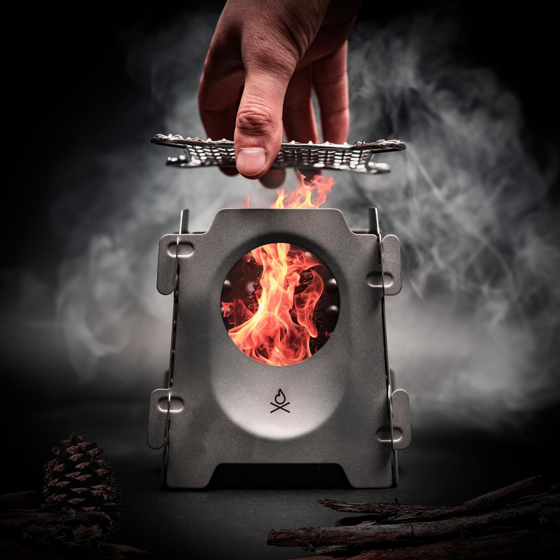 The Stöker Stove by Überleben in Titanium with grate and fire.