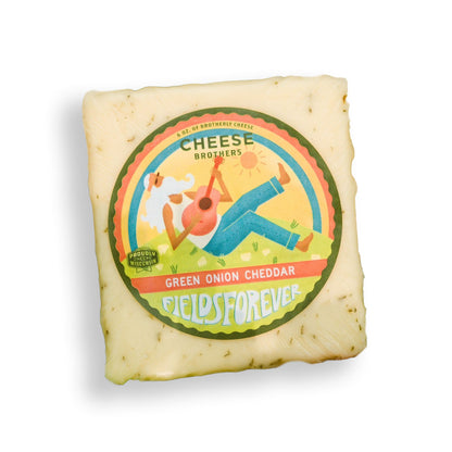 A block of Green Onion Cheddar by Cheese Brothers, Inc. displayed on a white background sold by Kempain Family Outfitters.