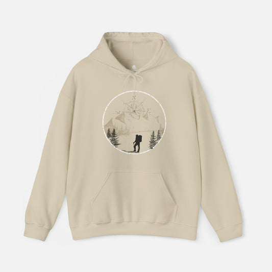 Sand color Hiking Graphic Hoodie displayed on white background, featuring a stunning hand-drawn illustration of majestic mountains and a compass rising in the sky. Whether you're exploring the trails or cozying up by the fire, this hoodie is the perfect companion for outdoor enthusiasts.