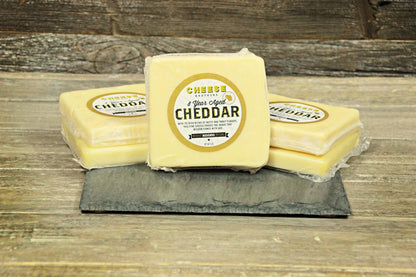 A Housewarming Gift Pack featuring Cheese Brothers 8-Year Aged Cheddar and Artisan Dill Havarti curated by Kempain Family Outfitters.