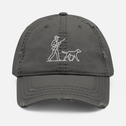 Front view of grey low-profile dad hat with line art embroidery of a hunter and dog in classic outdoor scene.