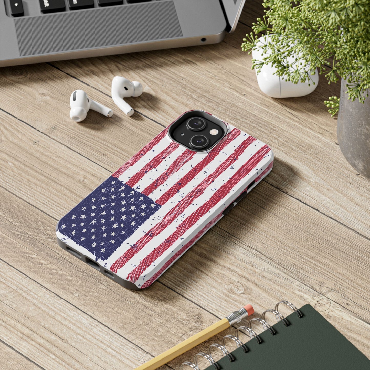 iPhone and Samsung phone case with an illustrated American flag design, placed on a desk in an office setting, adding a patriotic and stylish touch to your workspace.