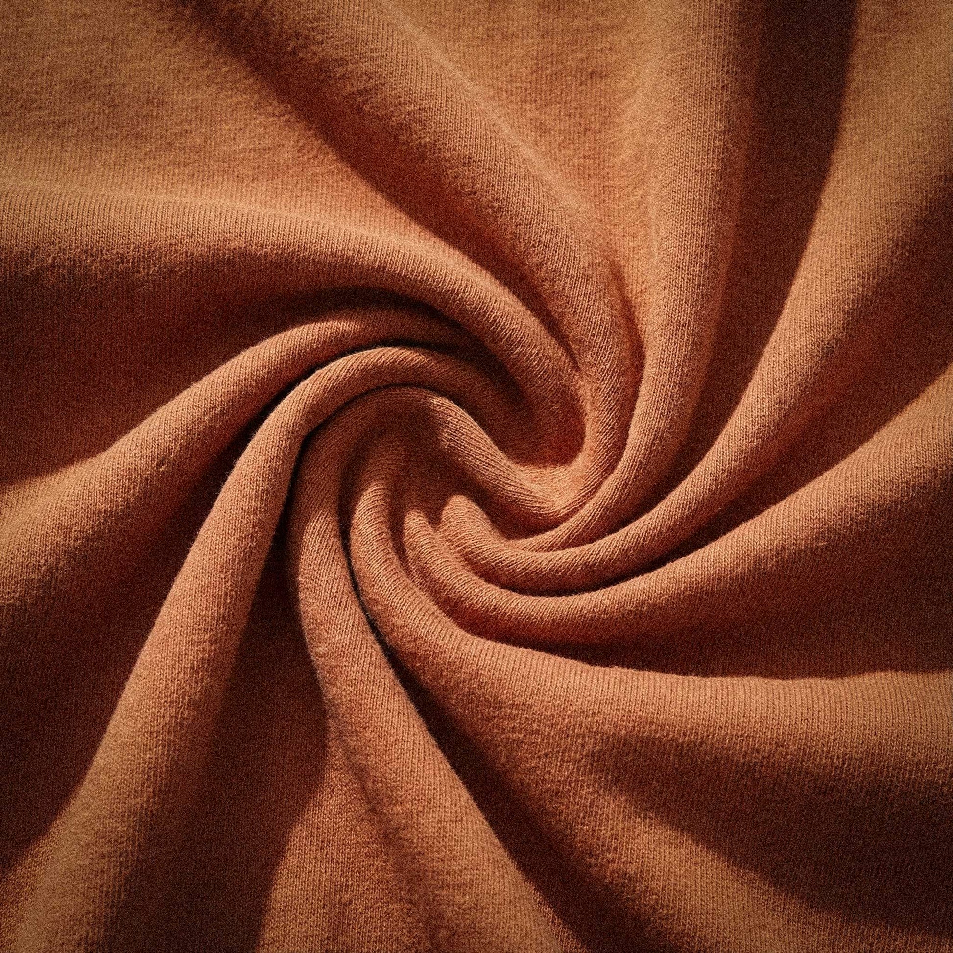 Macro detail of 100% ring-spun US cotton fabric in terracotta (Yam), showcasing the 6.4 oz field weight and breathable natural fiber texture of the Artist Series Comfort Colors 1466 with zero synthetic blends.