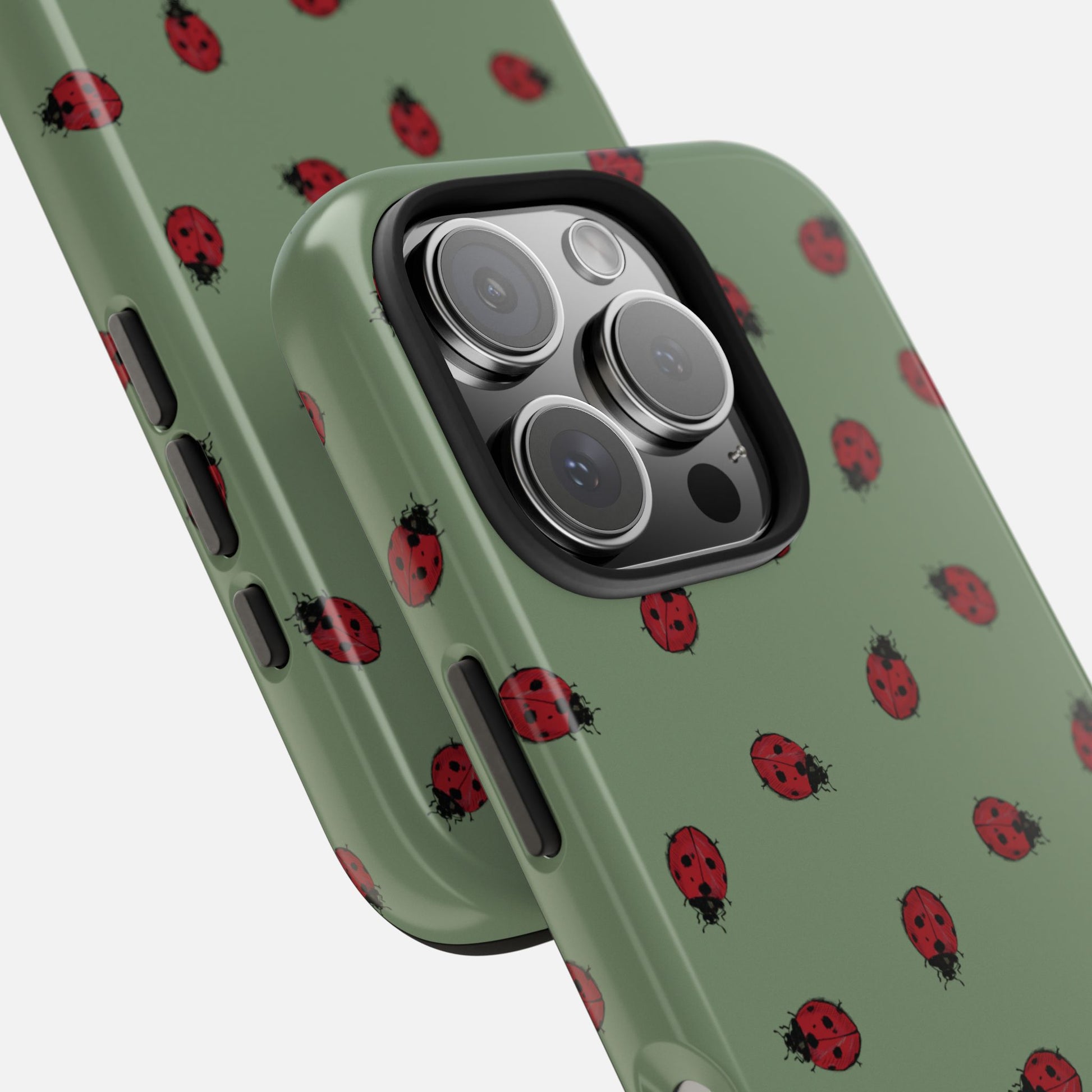 Phone case with ladybug pattern on a green background