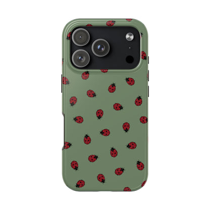 Phone case with ladybug pattern on a green background