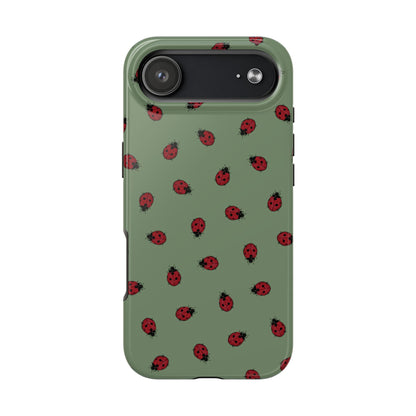 Phone case with ladybug pattern on a green background