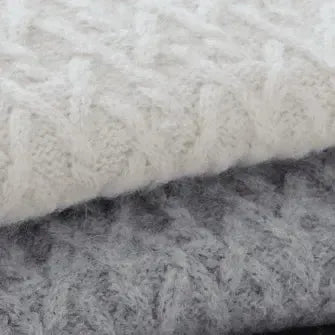 Stack of knitted fabric in white, gray, and black.