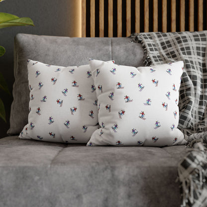 Lifestyle view of two pillow cases with an illustrated skier pattern, titled 'Carving the Slopes,' placed on a couch, bringing a winter sports-inspired touch to the living room decor.