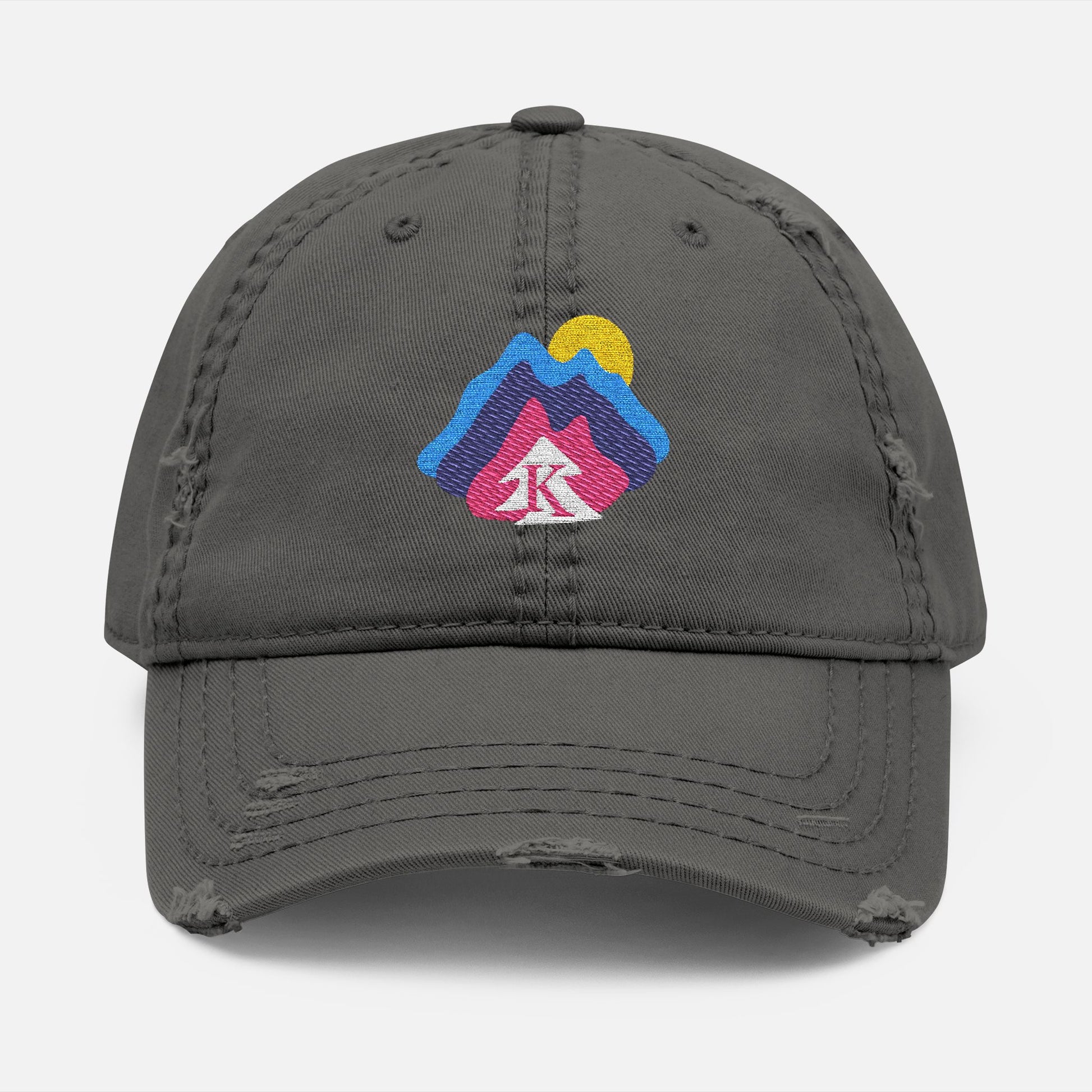  Front view of grey distressed dad hat on white background, featuring an embroidered mountain and sun design with the Kempain Family Outfitters tree + K emblem.