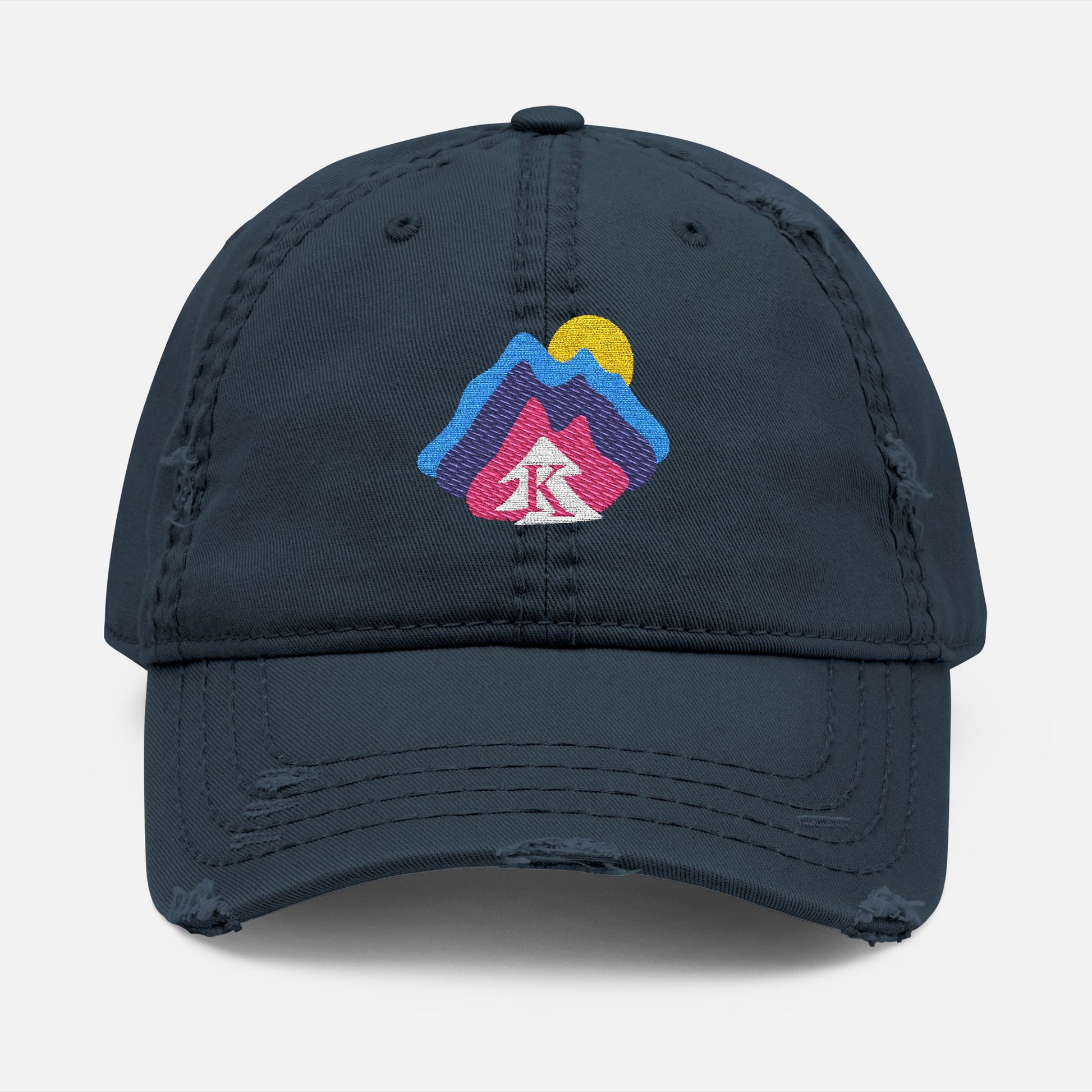  Front view of navy distressed dad hat on white background, featuring an embroidered mountain and sun design with the Kempain Family Outfitters tree + K emblem.