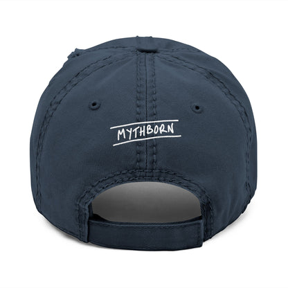 Back view of navy distressed dad hat with adjustable strap, featuring the word "Mythborn" as a nod to the Jackalope design on front.