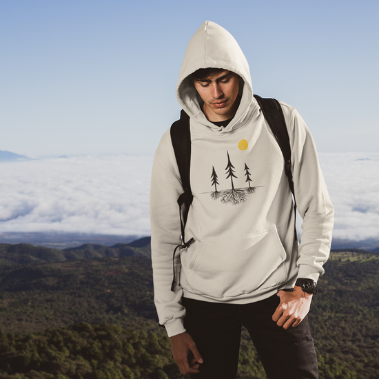 Video showing Sand Colored nature-inspired hoodie featuring a tree silhouette with exposed roots and a sun design. Unisex pullover sweatshirt displayed on a white background, showcasing minimalist outdoor apparel for forest lovers and hikers.