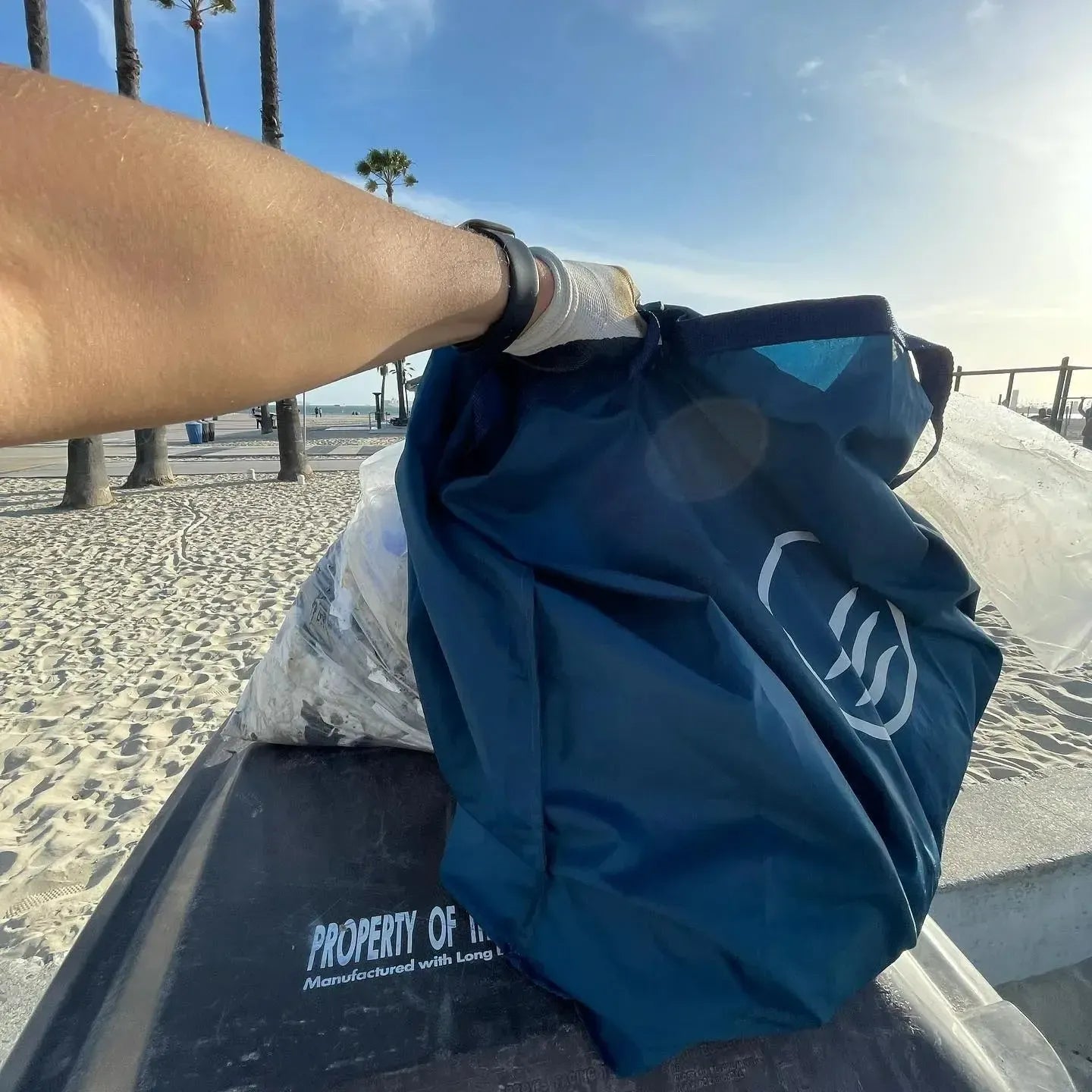 First person point of view using the reusable do it yourself trash cleanup Kit by United By Blue.