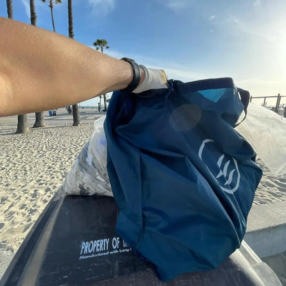 First person point of view using the reusable do it yourself trash cleanup Kit by United By Blue.