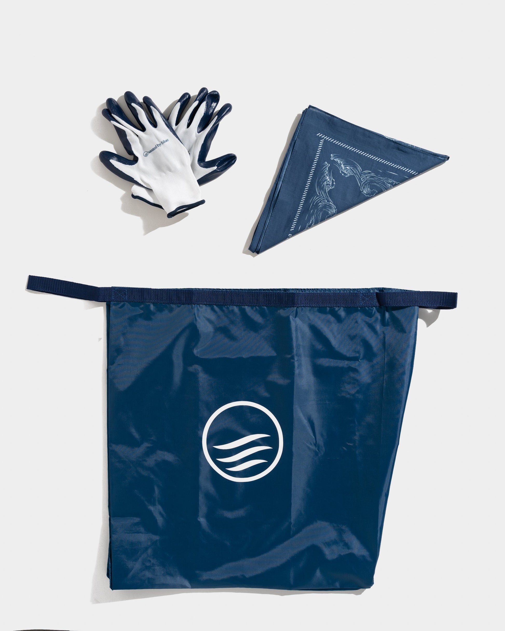 Components of the reusable do it yourself trash cleanup Kit - recycled and organic by United By Blue displayed on a white background.