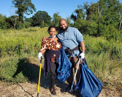 A couple picking up trash using the reusable do it yourself trash cleanup Kit by United By Blue.