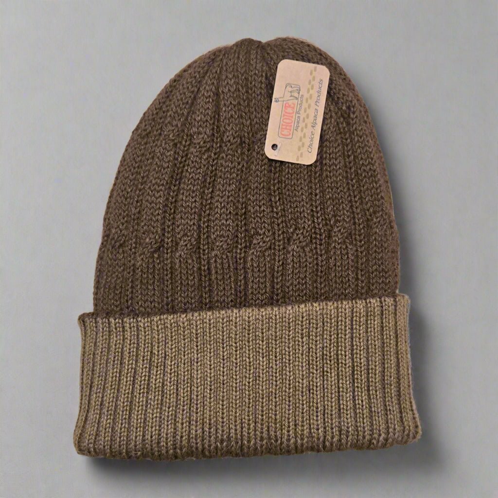 100% alpaca brown knit beanie with a tag on a gray background