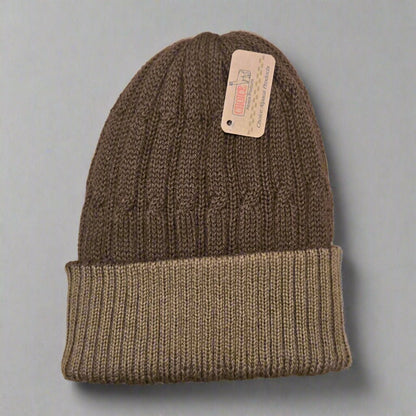 100% alpaca brown knit beanie with a tag on a gray background