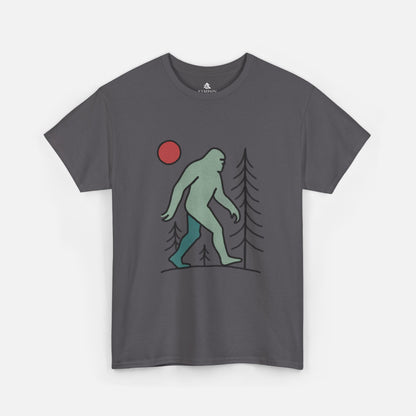 Flat lay of the Sasquatch Red Moon Forest Tee in dark grey color on a white background, featuring a minimalist line art design of Bigfoot walking through pine trees under a red moon