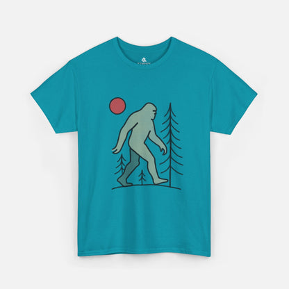 Flat lay of the Sasquatch Red Moon Forest Tee in tropical blue color on a white background, featuring a minimalist line art design of Bigfoot walking through pine trees under a red moon