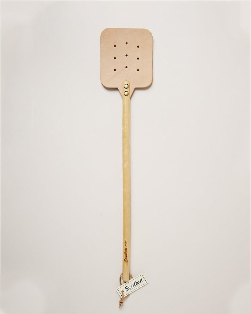 The maple color Leather Huntsman Flyswatter by Farmhouse Pottery sold by Kempain Family Outfitters displayed on solid gray background.