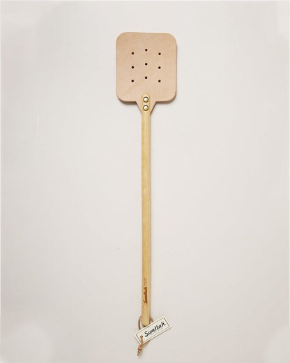 The maple color Leather Huntsman Flyswatter by Farmhouse Pottery sold by Kempain Family Outfitters displayed on solid gray background.