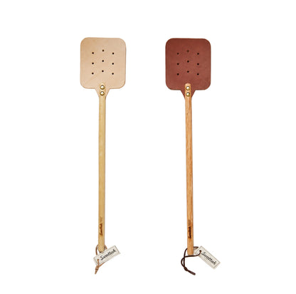 The Leather Huntsman Flyswatter by Farmhouse Pottery displayed on a solid white background sold by Kempain Family Outfitters.
