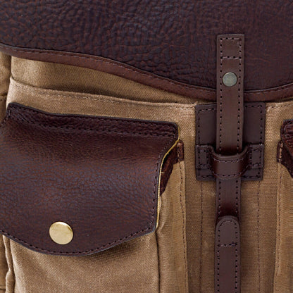 Close up of leather and hardware on The Waxed Canvas Backpack in Smoke-Brown by Mission Mercantile Leather Goods.