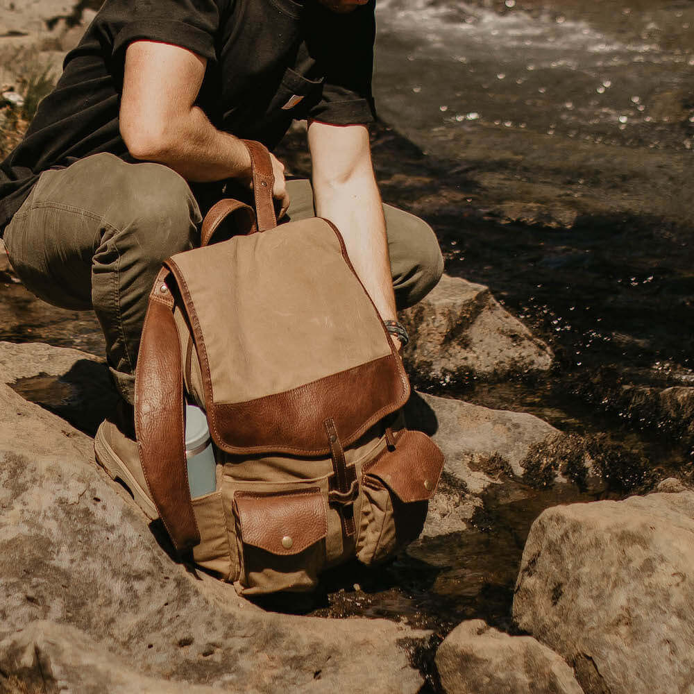 Outdoor Lifestyle view of The Waxed Canvas Backpack in Smoke-Brown by Mission Mercantile Leather Goods.