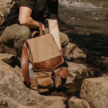 Outdoor Lifestyle view of The Waxed Canvas Backpack in Smoke-Brown by Mission Mercantile Leather Goods.