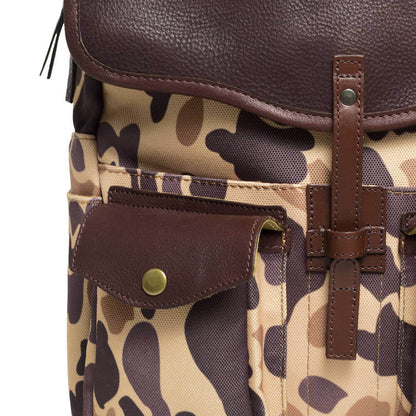Close up view of The Waxed Canvas Backpack in Smoke-Vintage-Camo by Mission Mercantile Leather Goods showing leather texture and hardware.
