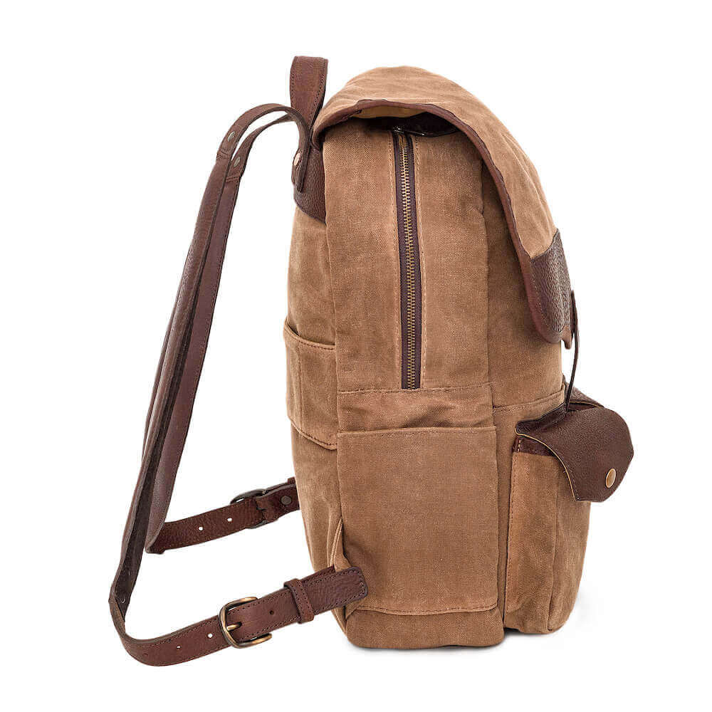 Side profile of The Waxed Canvas Backpack in Smoke-Brown by Mission Mercantile Leather Goods on a white background.