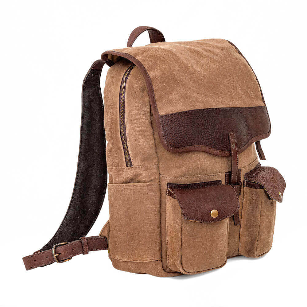 Side angle profile of The Waxed Canvas Backpack in Smoke-Brown by Mission Mercantile Leather Goods on white background.