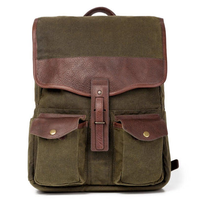 Front view of The Waxed Canvas Backpack in smoke-forest by Mission Mercantile Leather Goods on a white background.