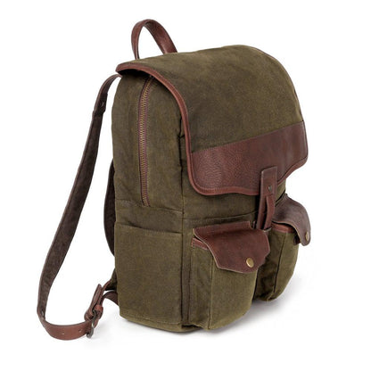 Side angle view of The Waxed Canvas Backpack in smoke-forest by Mission Mercantile Leather Goods on a white background.