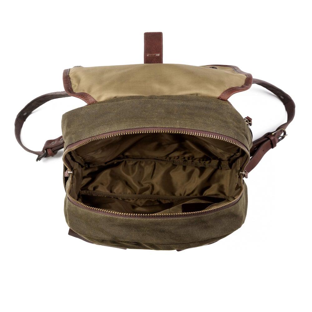 Top view of The Waxed Canvas Backpack in smoke-forest by Mission Mercantile Leather Goods on a white background.