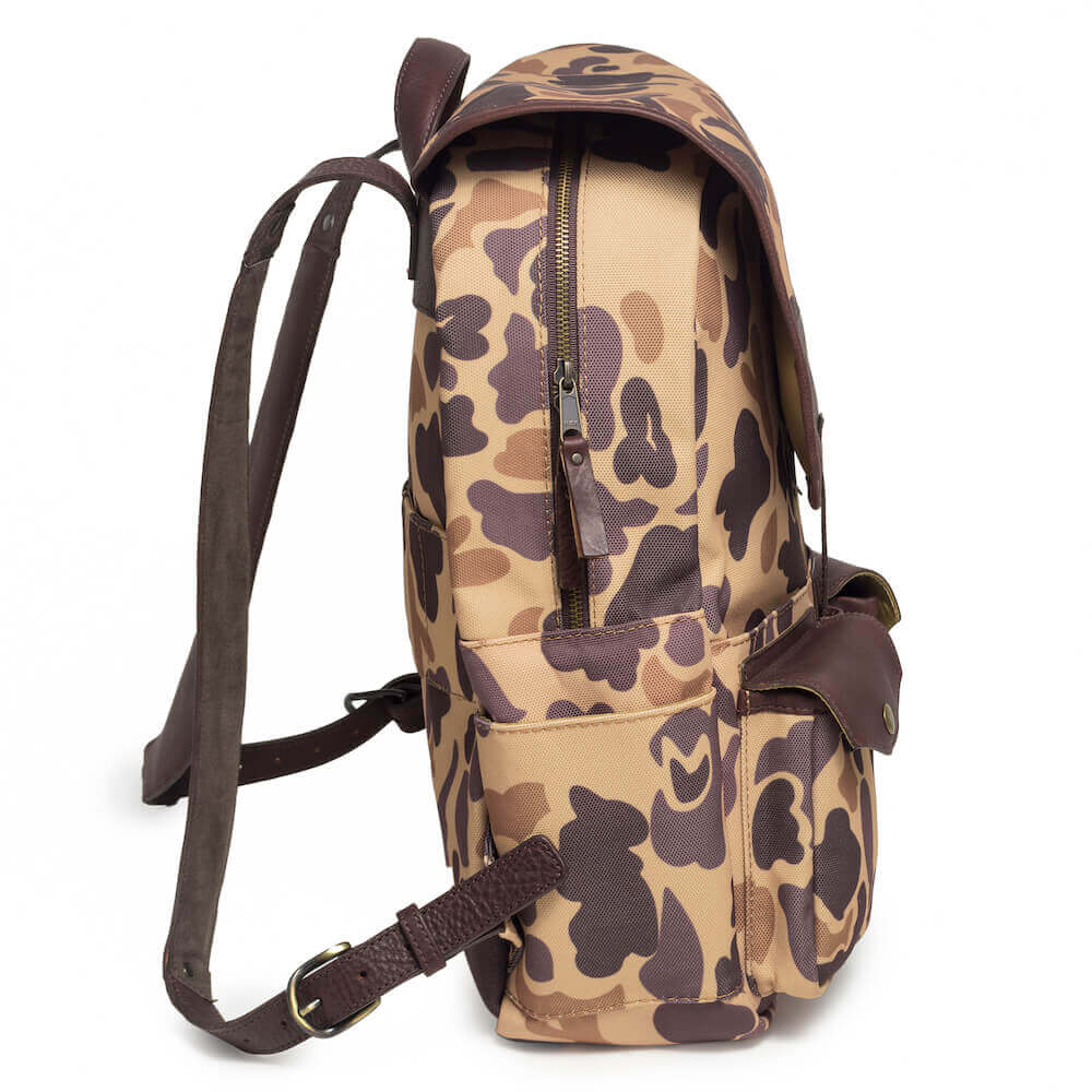 Side profile of The Waxed Canvas Backpack in Smoke-Vintage-Camo by Mission Mercantile Leather Goods.