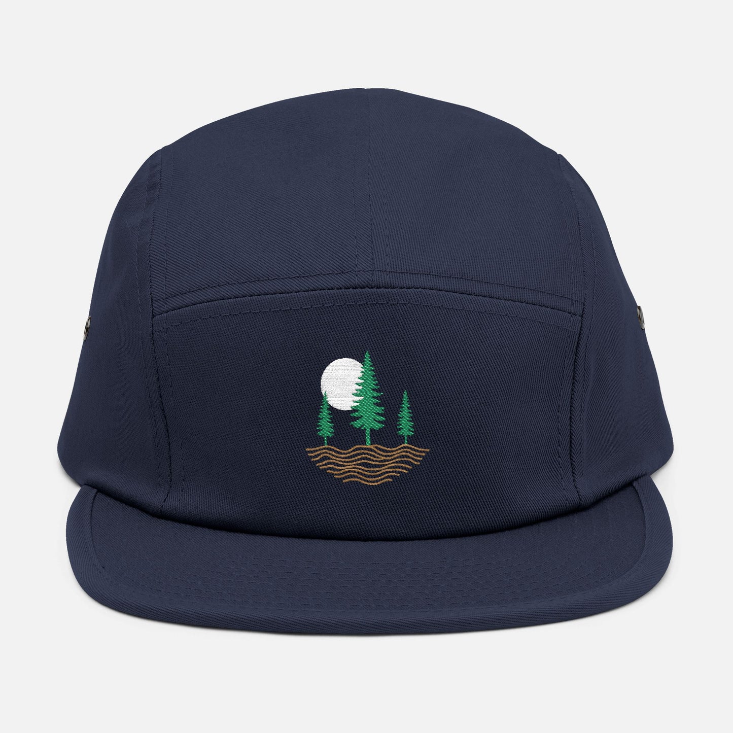 Front view of navy low-profile cap with embroidered design of three pine trees, a rising sun, and ripple lines symbolizing the earth.