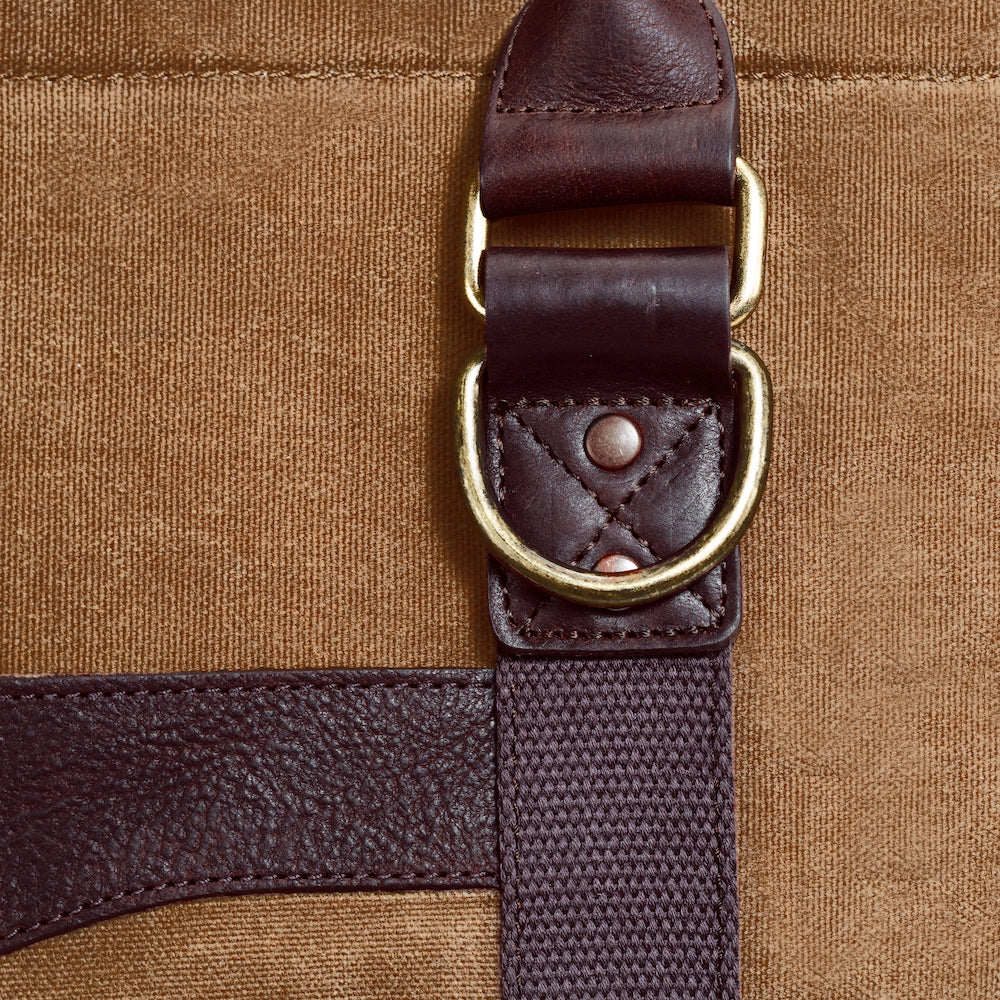 Close up of a buckle on the White Wing Waxed Canvas Large Cooler - 35L in Smoke-Brown by Mission Mercantile Leather Goods.