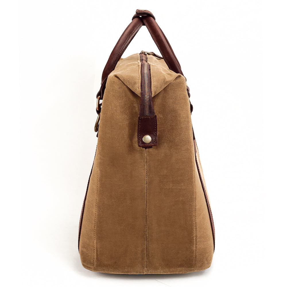 Side view of the White Wing Waxed Canvas Large Cooler - 35L in Smoke-Brown by Mission Mercantile Leather Goods.