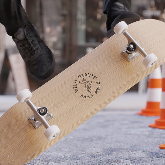 Skateboard with 'Wild Giants Rome Free' sticker on back showcasing the sticker design.