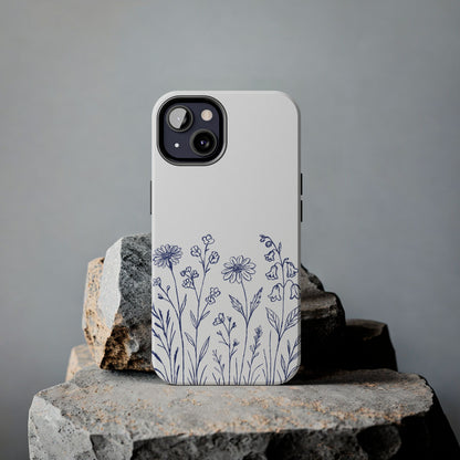 Wildflower Blue Phone Case featuring delicate hand-drawn floral design in serene blue on a rock.