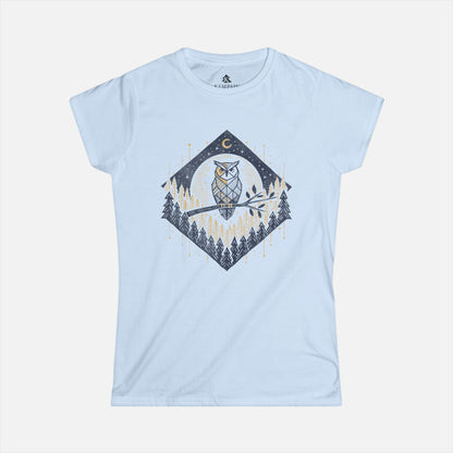 Women’s Owl & Pine Forest T-Shirt in light blue displayed flat on a white background, showcasing its geometric forest and owl illustration.